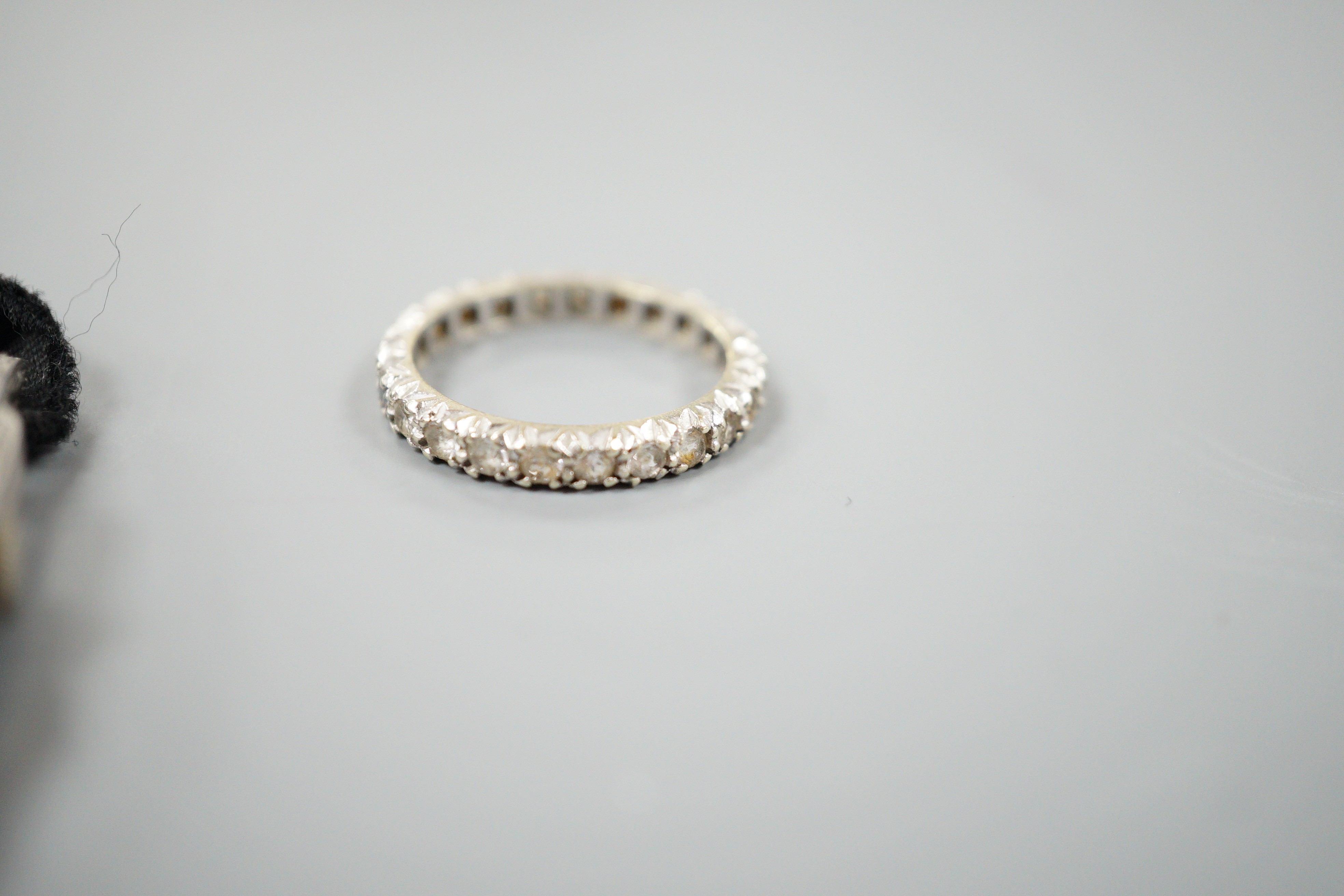 A lady's white metal (stamped all platinum) and diamond set manual wind cocktail watch, gross weight 13.2 grams and a 9ct white metal and synthetic white spinel set full eternity ring.